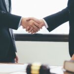 Two people shaking hands, symbolizing trust, partnership, and professional collaboration.