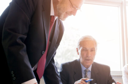2147923423 Two lawyers reviewing the contract paper.