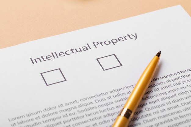 Intellectual property document with checkboxes and a pen placed on a desk.
