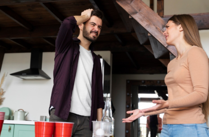 Frustrated couple having serious discussion during social gathering with friends at home