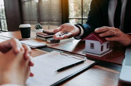ss2 Real estate agent handing over house keys during a property purchase meeting